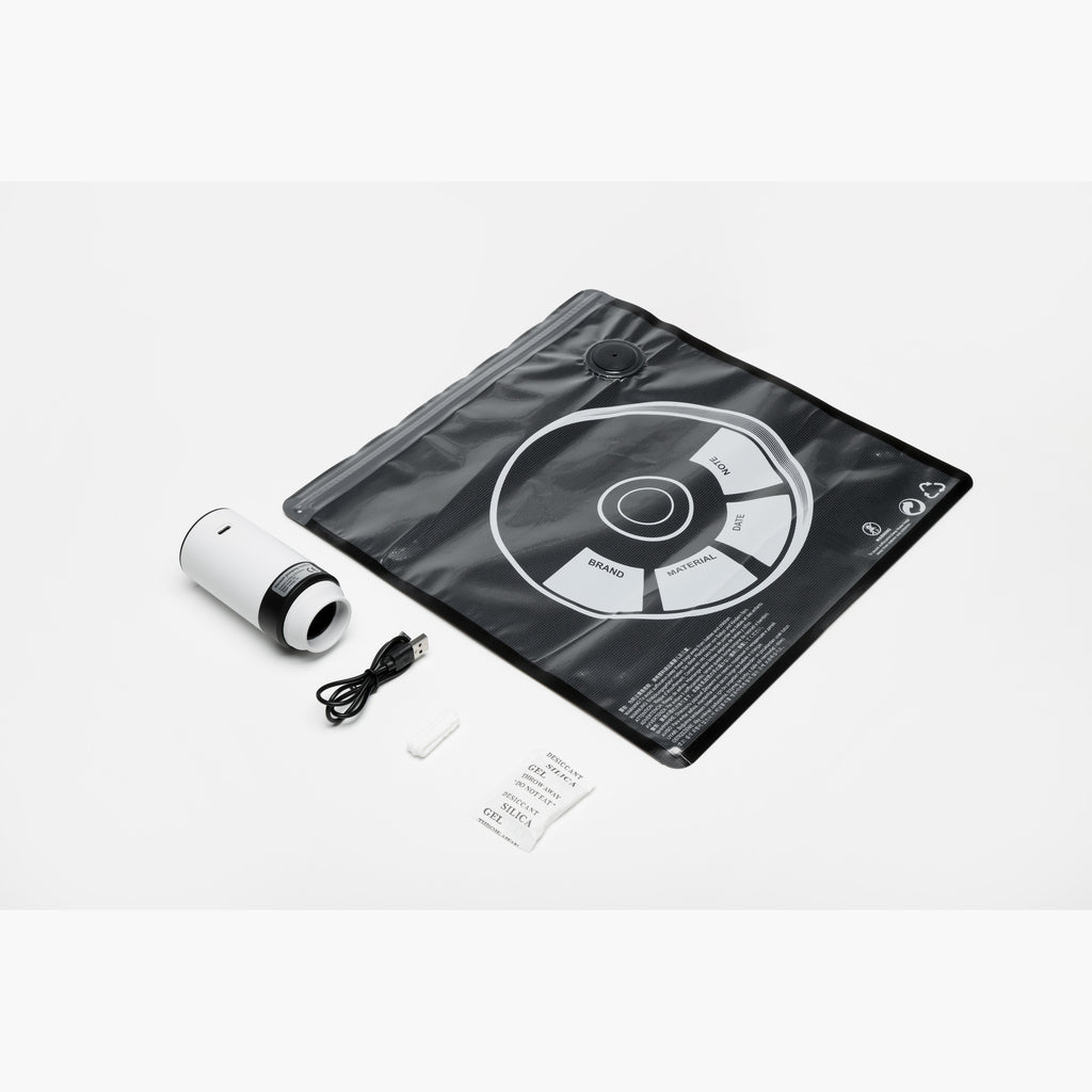 Filament vacuum storage kit overview with bag, pump, USB cable, and desiccant on a light background